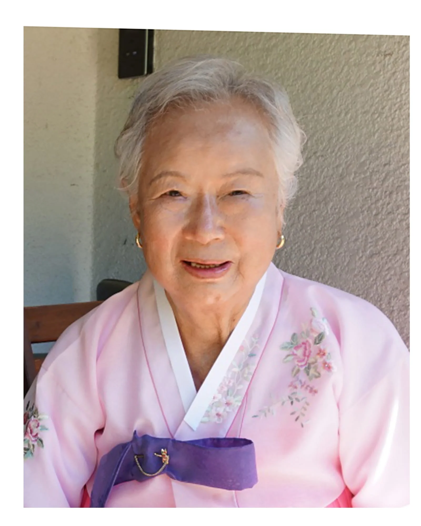 Hanbok memorial — grandmother's hanbok portrait against a warm pink background — before