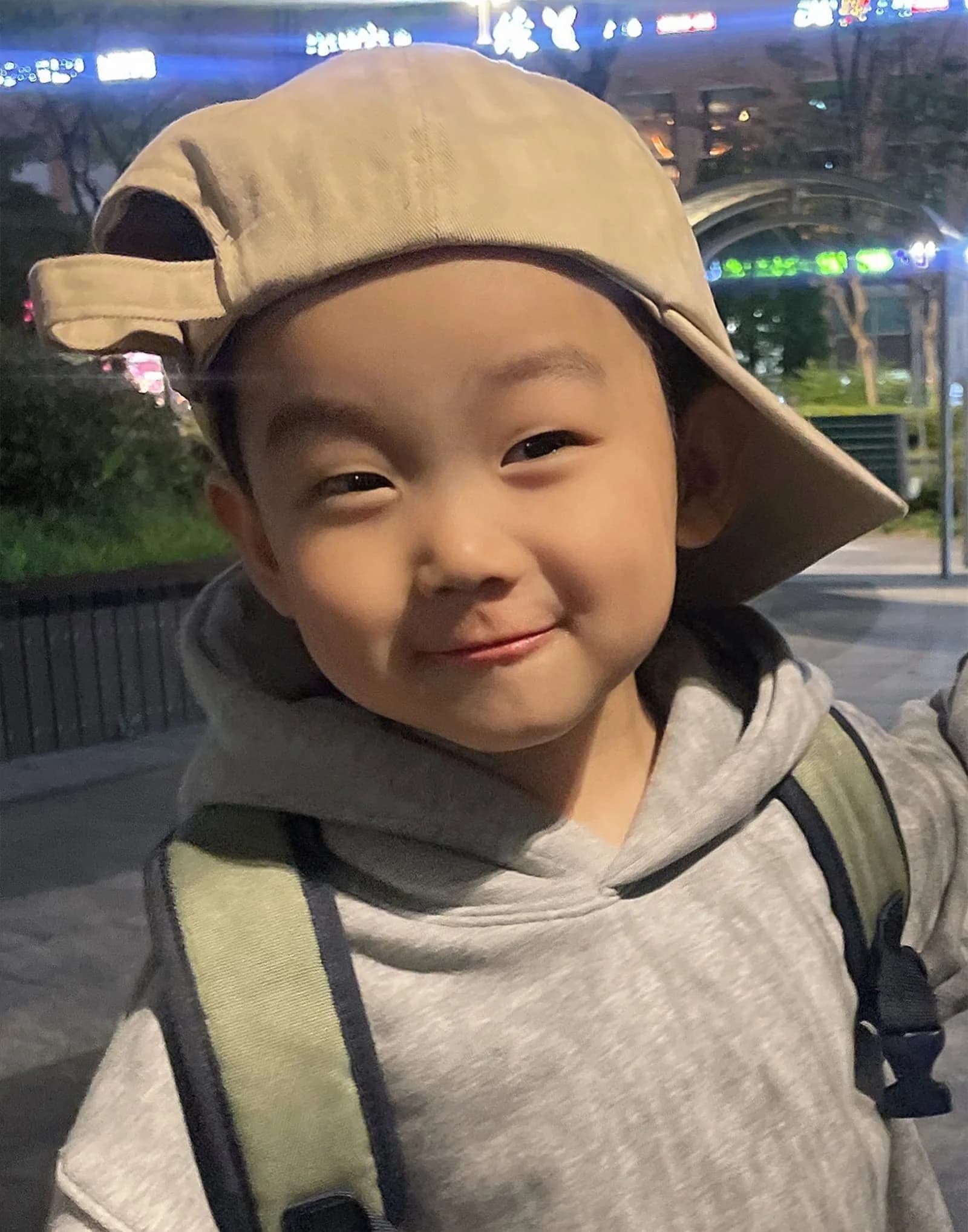 Oil-style portrait (child) — a nighttime phone selfie in warm brown tones — before